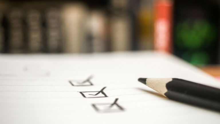 paper checklist with a black leaded pencil