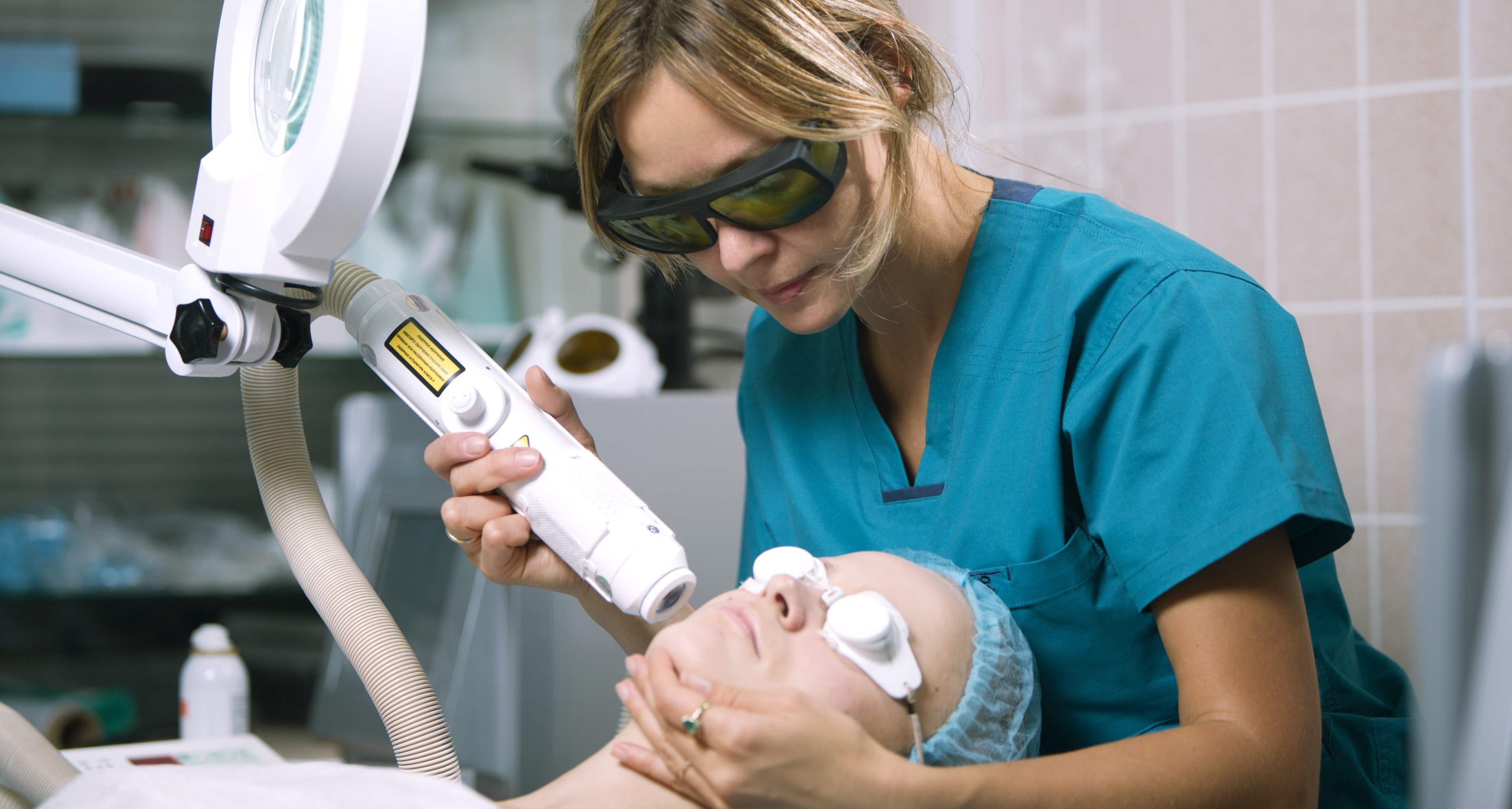 woman receiving laser treatment on face